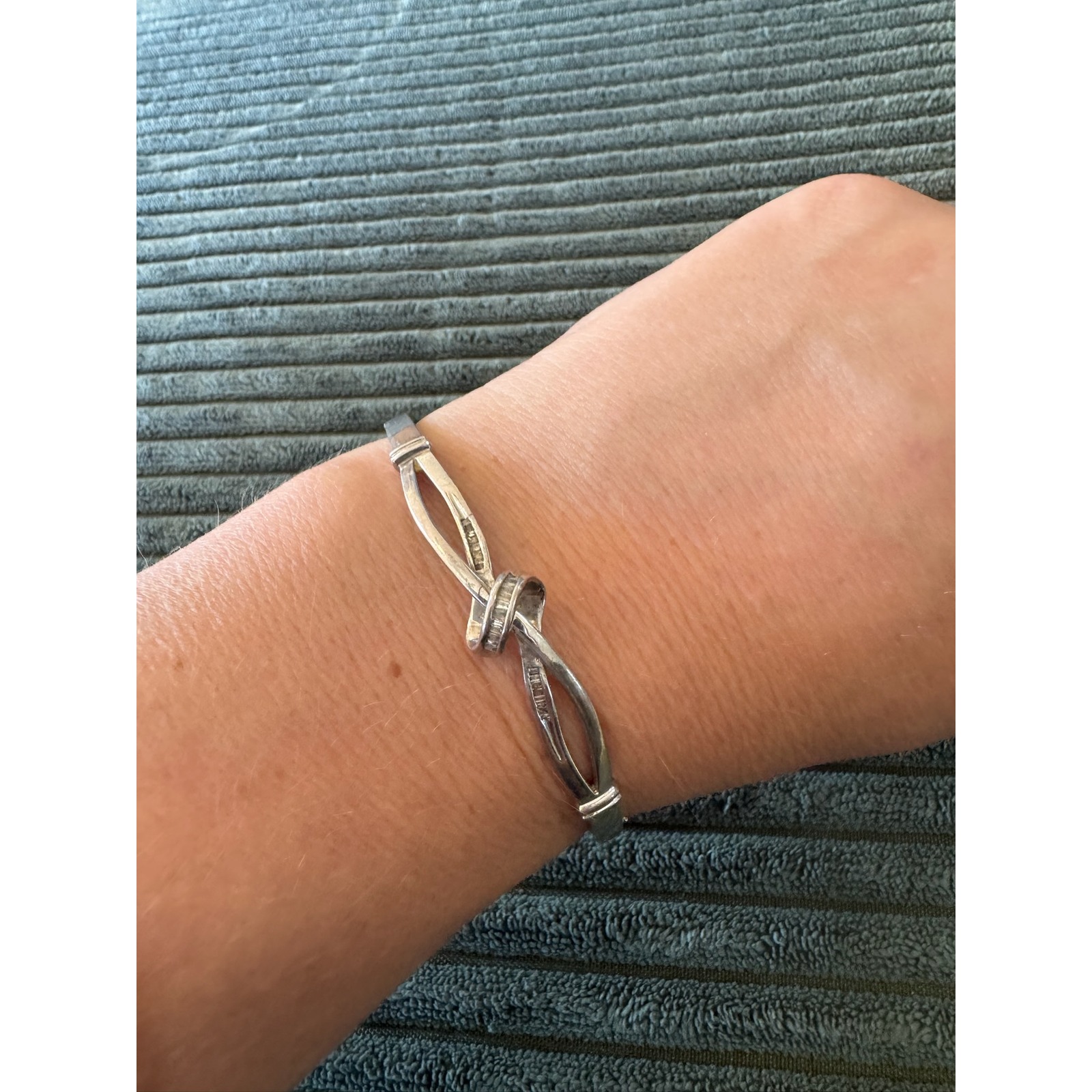 Sterling Silver Bangle Bracelet With Knot Design And Baguette Accents